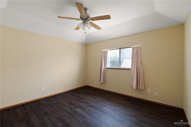 spare room featuring ceiling fan, dark wood-type flooring, and vaulted ceiling