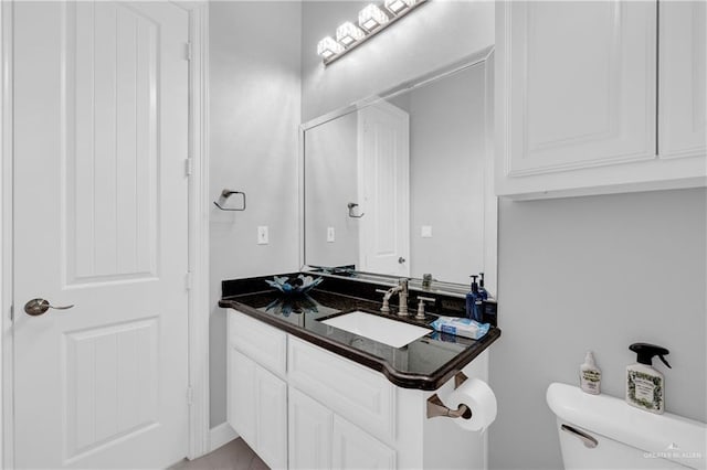 bathroom with toilet and vanity