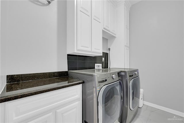 laundry area with cabinets and separate washer and dryer