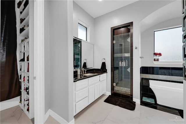 bathroom featuring vanity and shower with separate bathtub