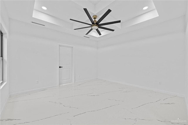 unfurnished room featuring a tray ceiling, visible vents, baseboards, and recessed lighting