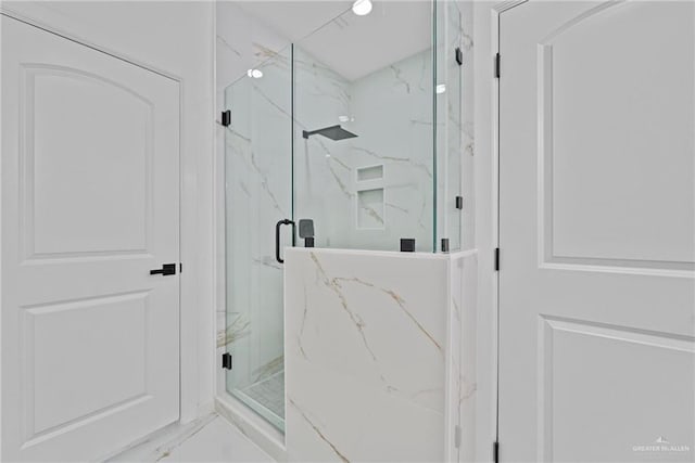 bathroom featuring marble finish floor and a marble finish shower