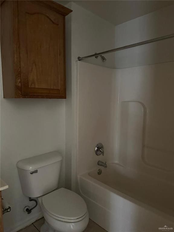 full bath featuring toilet, tile patterned flooring, and shower / washtub combination