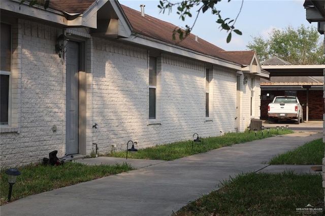 view of side of home with brick siding