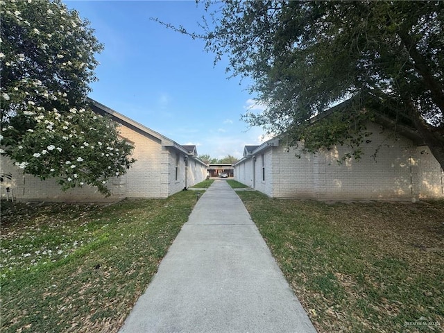 view of home's exterior with a yard and brick siding
