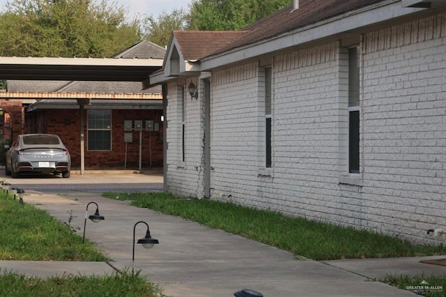view of side of property with brick siding