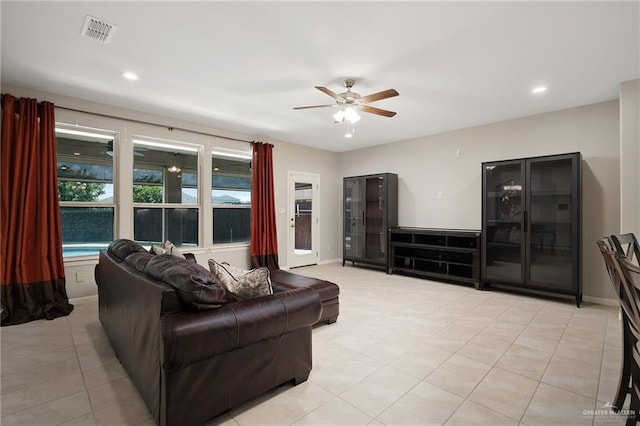 tiled living room with ceiling fan