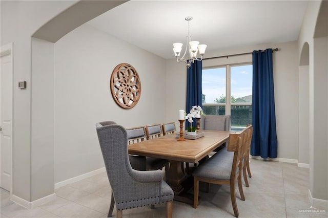 tiled dining area with an inviting chandelier