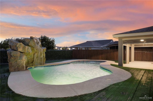 pool at dusk with a patio