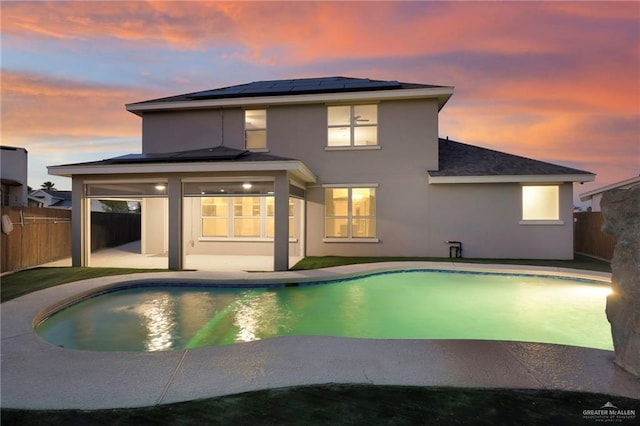 pool at dusk featuring a patio area