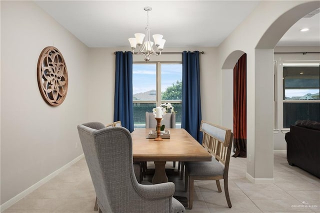 dining area with an inviting chandelier and light tile patterned floors