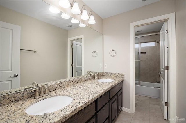 bathroom featuring tile patterned floors, vanity, and enclosed tub / shower combo