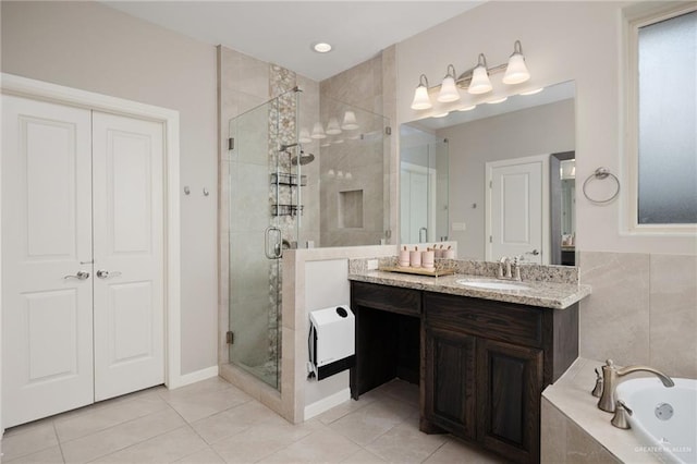 bathroom featuring tile patterned floors, vanity, and shower with separate bathtub