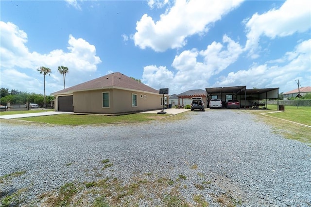 1833 Cortez Dr, Alamo, TX 78516 - view of side of property with driveway, a carport, and a garage