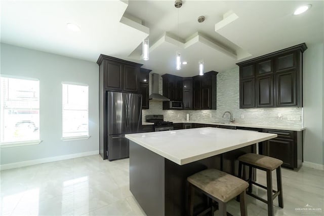 1833 Cortez Dr, Alamo, TX 78516 - kitchen featuring stainless steel appliances, wall chimney exhaust hood, backsplash, a breakfast bar area, and recessed lighting