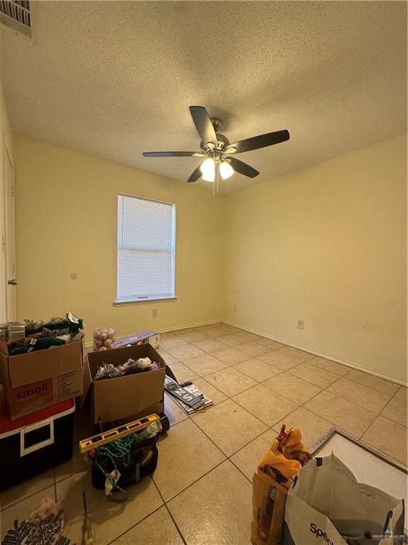 9205 N 31st St, Mcallen, TX 78504 - spare room with tile patterned flooring, ceiling fan, and a textured ceiling