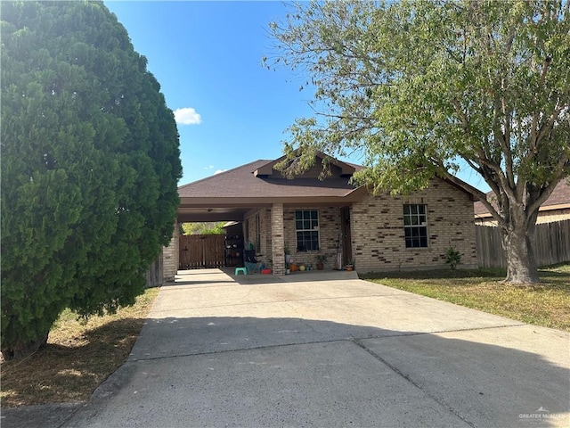 view of front facade featuring a front lawn and a carport