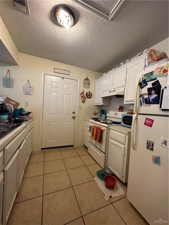 9205 N 31st St, Mcallen, TX 78504 - kitchen with white cabinets, white appliances, a textured ceiling, and light tile patterned floors