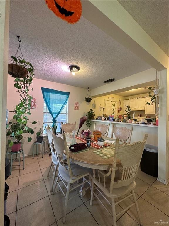 9205 N 31st St, Mcallen, TX 78504 - tiled dining room featuring a textured ceiling