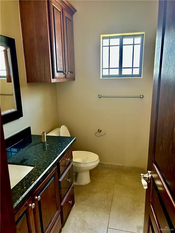 bathroom with tile patterned floors, vanity, and toilet