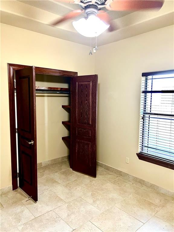 bedroom featuring ceiling fan and a closet