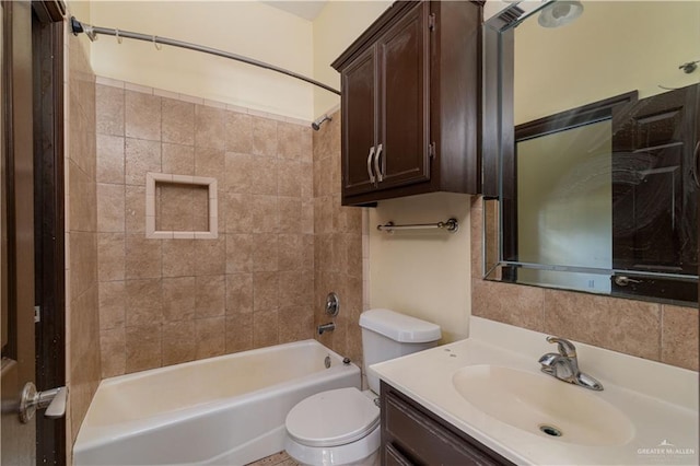 full bathroom with toilet, vanity, and tiled shower / bath