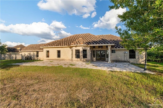 rear view of property with a yard and a patio