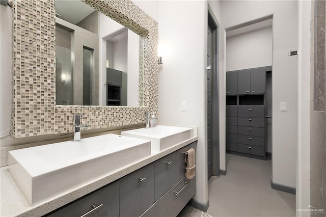 bathroom featuring decorative backsplash, vanity, and concrete floors