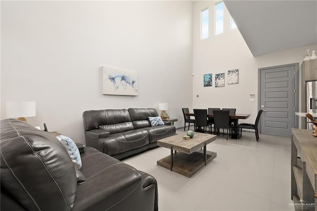 tiled living room featuring a high ceiling