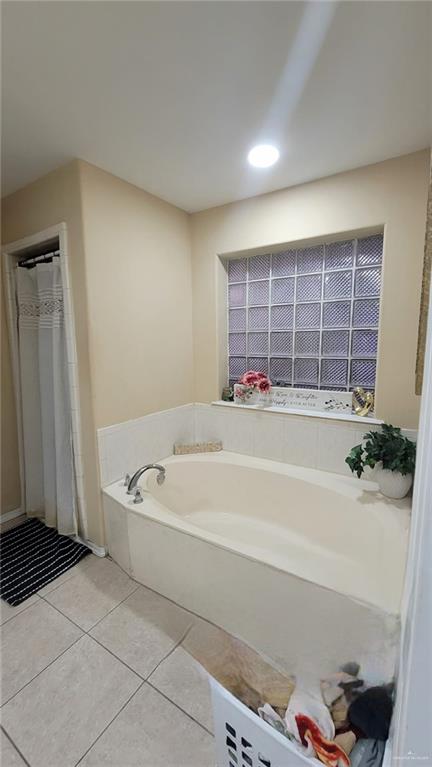 bathroom featuring tile patterned flooring and a bathing tub