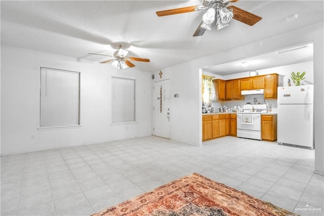 kitchen featuring ceiling fan, light tile patterned floors, and white appliances