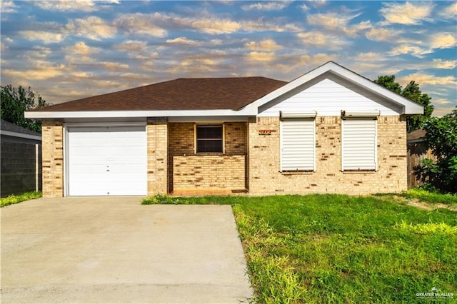 single story home featuring a lawn and a garage