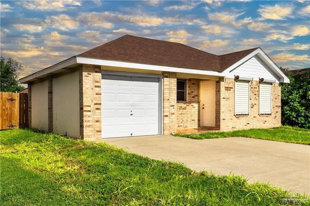 single story home featuring a yard and a garage