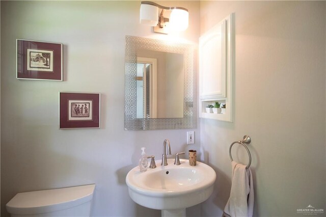 513 S Cynthia St, Mcallen, TX 78501 - half bathroom with a sink and toilet