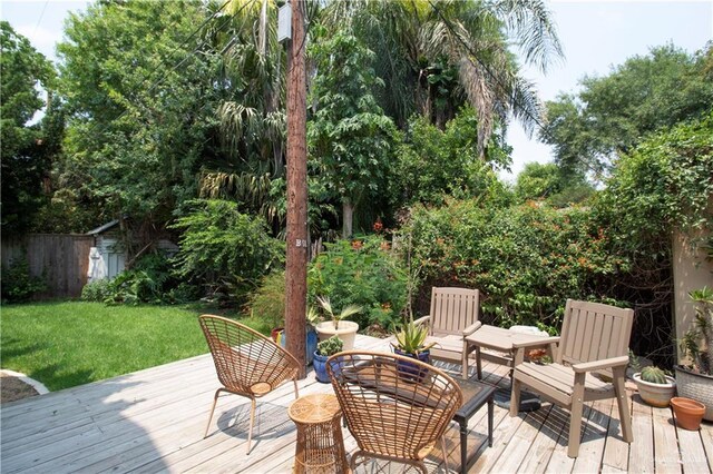 513 S Cynthia St, Mcallen, TX 78501 - deck with a storage shed, a yard, and outdoor dining area