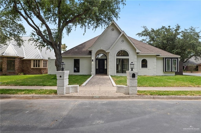 600 Bluebird Ave, Mcallen, TX 78504 - view of front of property featuring brick siding, a front yard, and roof with shingles
