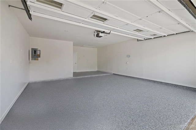 600 Bluebird Ave, Mcallen, TX 78504 - garage with baseboards, electric panel, and a garage door opener