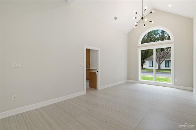 600 Bluebird Ave, Mcallen, TX 78504 - empty room with a chandelier, high vaulted ceiling, and baseboards