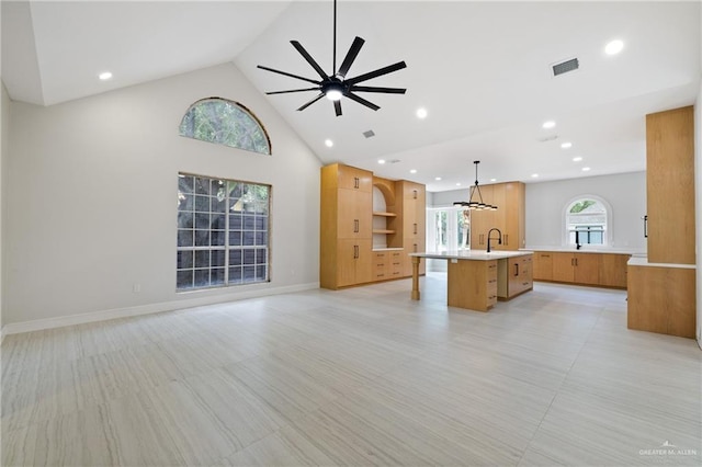 600 Bluebird Ave, Mcallen, TX 78504 - unfurnished living room featuring ceiling fan, recessed lighting, high vaulted ceiling, a sink, and baseboards