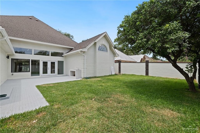 600 Bluebird Ave, Mcallen, TX 78504 - rear view of house with a lawn and french doors