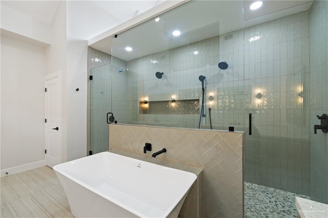 600 Bluebird Ave, Mcallen, TX 78504 - bathroom featuring a stall shower, a freestanding bath, recessed lighting, and baseboards