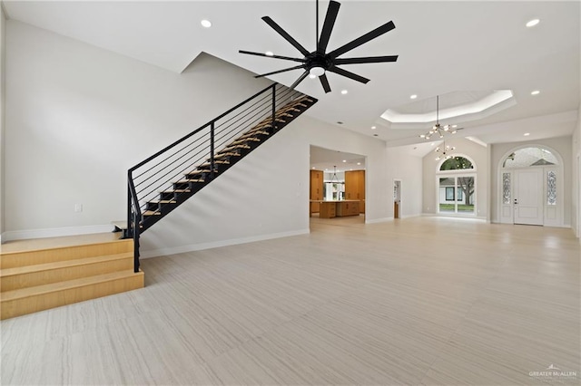 600 Bluebird Ave, Mcallen, TX 78504 - unfurnished living room featuring stairs, a raised ceiling, recessed lighting, baseboards, and a chandelier