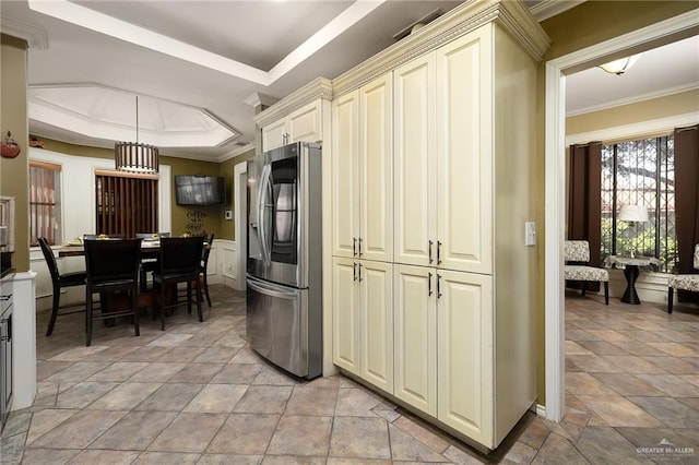 kitchen featuring stainless steel fridge with ice dispenser, crown molding, cream cabinetry, and a raised ceiling