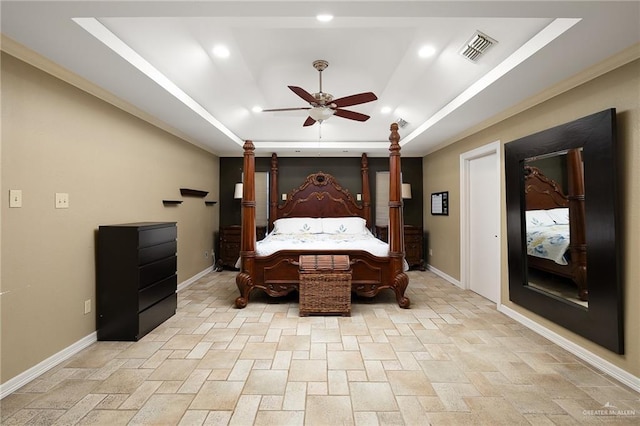 bedroom featuring a tray ceiling and ceiling fan