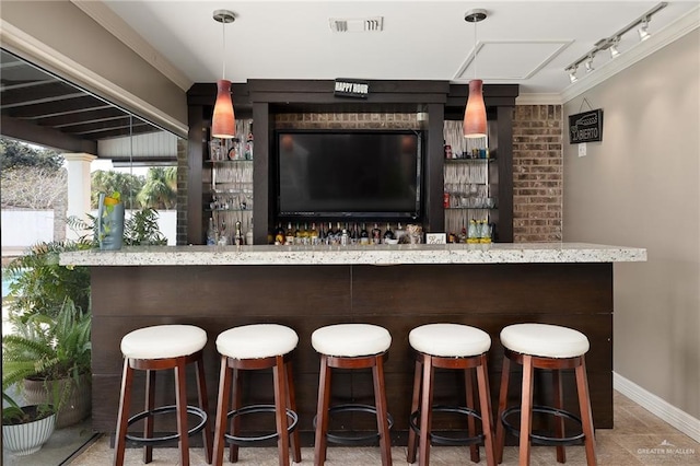 bar featuring decorative light fixtures and track lighting