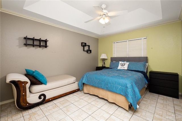 bedroom featuring crown molding, ceiling fan, and a tray ceiling