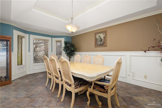 dining space featuring ornamental molding and a tray ceiling