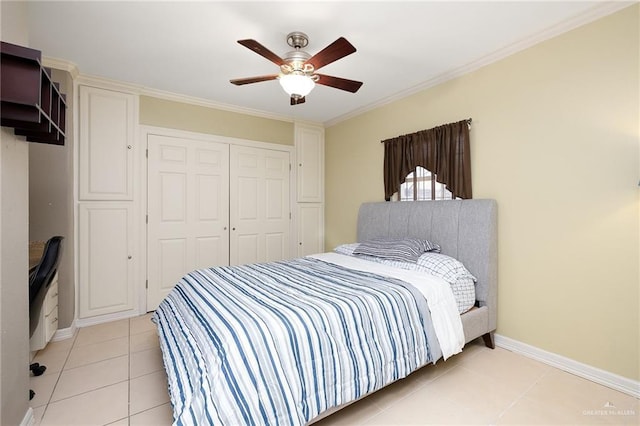 tiled bedroom with crown molding, ceiling fan, and a closet