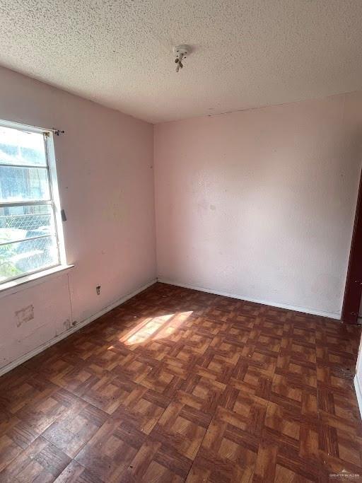 spare room with a textured ceiling