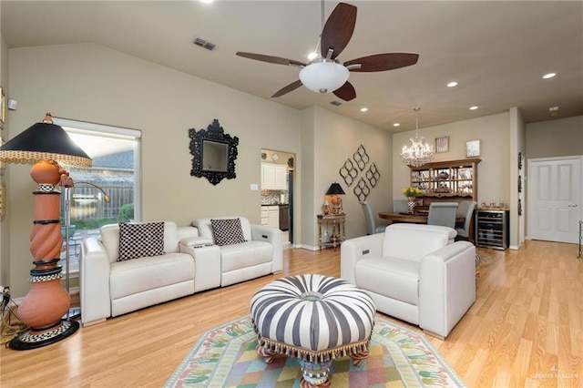 living room with visible vents, light wood-style flooring, recessed lighting, wine cooler, and lofted ceiling